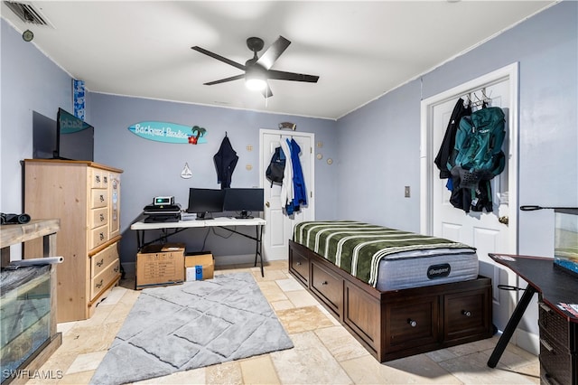 bedroom with ceiling fan and a closet