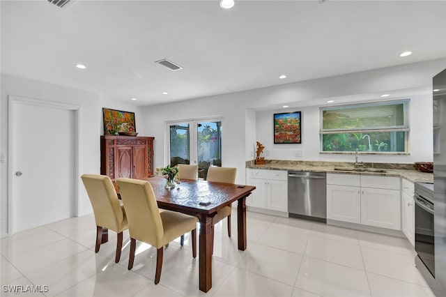 dining room featuring light tile patterned flooring and sink