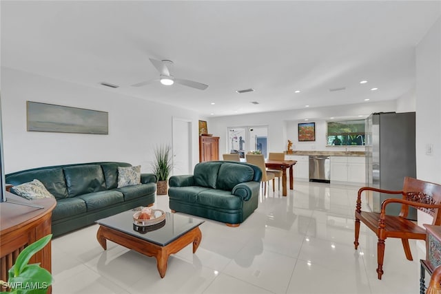 living room featuring ceiling fan and light tile patterned floors