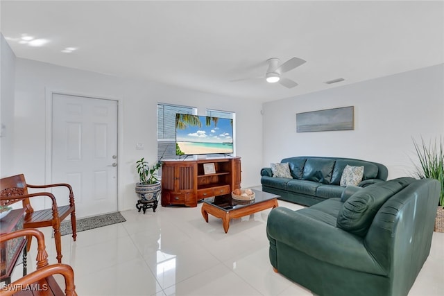 tiled living room with ceiling fan