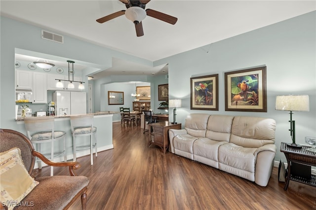 living room featuring dark hardwood / wood-style floors and ceiling fan