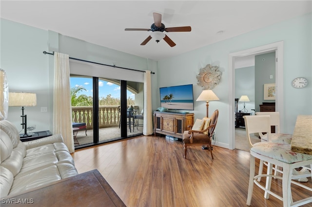 living room featuring wood-type flooring and ceiling fan