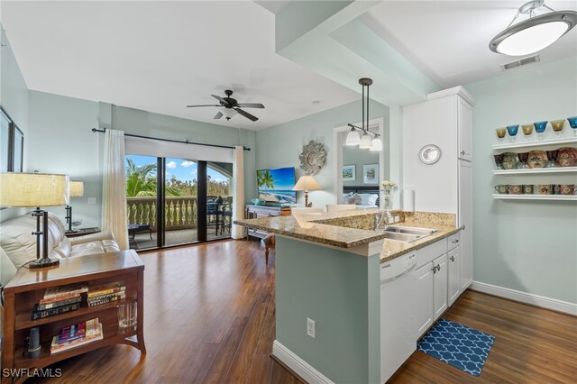 kitchen featuring dishwasher, white cabinets, sink, kitchen peninsula, and light stone counters