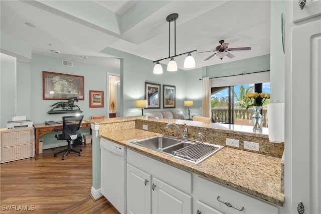 kitchen featuring pendant lighting, dark hardwood / wood-style flooring, sink, white dishwasher, and white cabinets