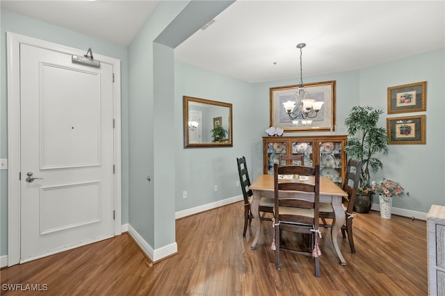 dining room featuring an inviting chandelier and wood-type flooring