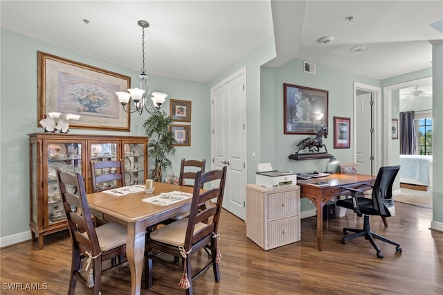 dining room featuring a notable chandelier and dark hardwood / wood-style flooring