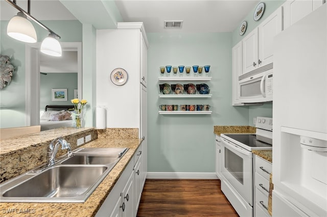 kitchen with sink, decorative light fixtures, white cabinetry, and white appliances