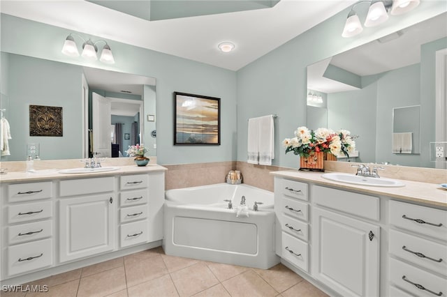 bathroom with a bathtub, tile patterned flooring, and vanity