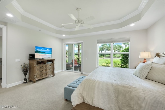 carpeted bedroom featuring access to exterior, baseboards, a tray ceiling, and ornamental molding