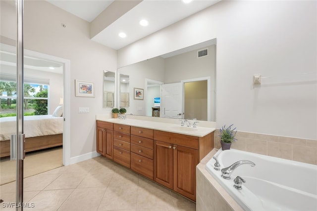 ensuite bathroom featuring visible vents, double vanity, tile patterned floors, ensuite bath, and a sink