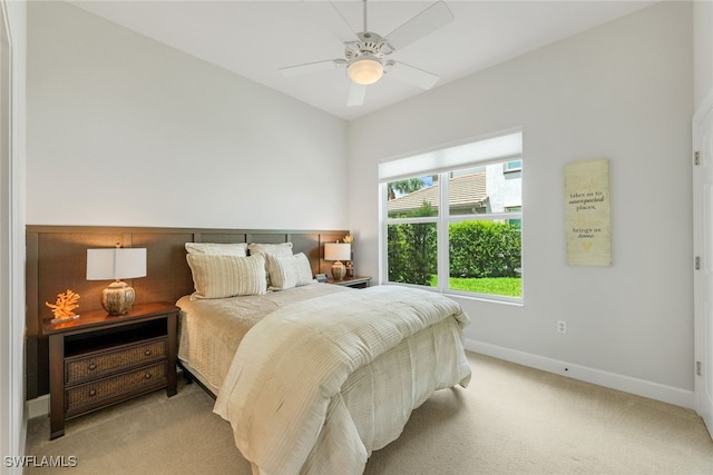 carpeted bedroom featuring a ceiling fan and baseboards