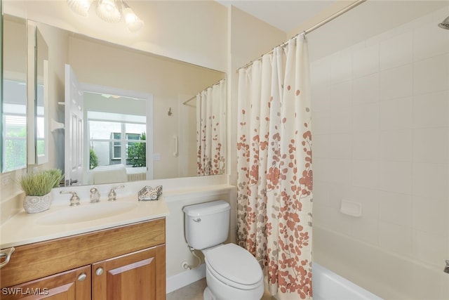 full bath featuring shower / bath combo with shower curtain, vanity, toilet, and ensuite bathroom