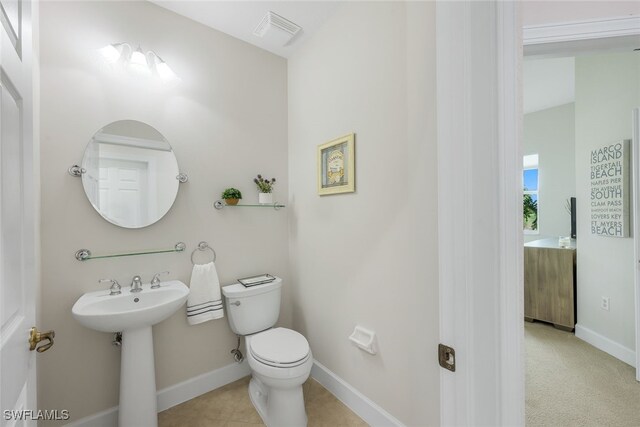 bathroom featuring tile patterned floors, toilet, baseboards, and visible vents