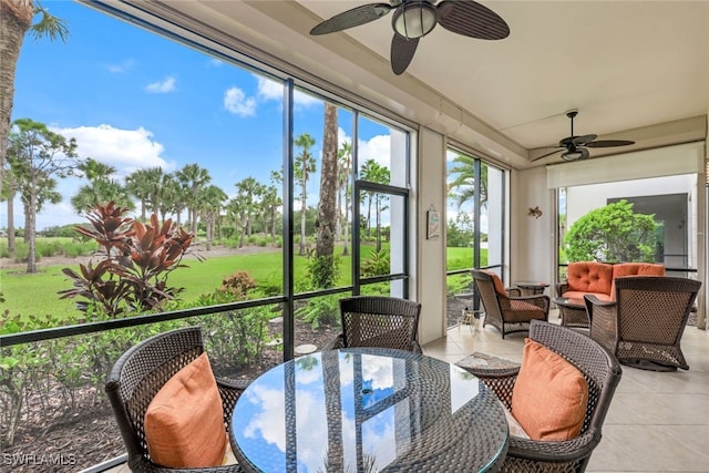 sunroom / solarium featuring a wealth of natural light and ceiling fan