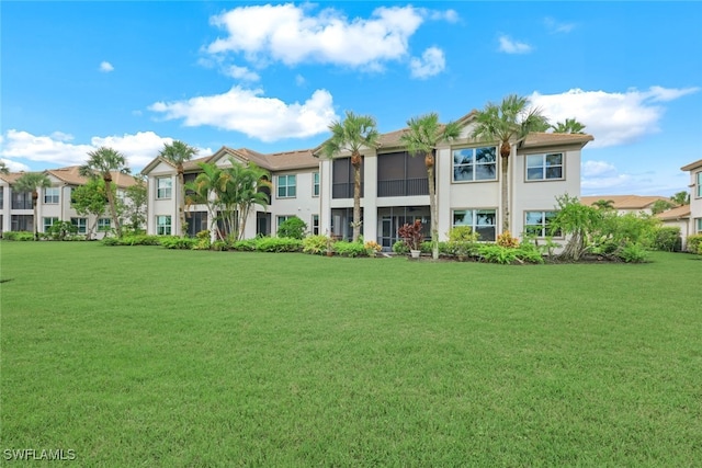 exterior space featuring a residential view, stucco siding, and a front lawn