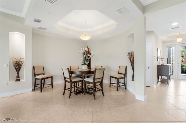 dining room featuring a raised ceiling, baseboards, and visible vents