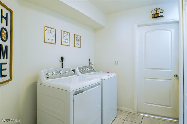 laundry room with light tile patterned floors and washing machine and dryer