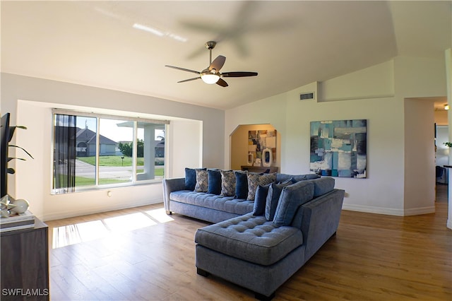 living room featuring lofted ceiling, hardwood / wood-style floors, and ceiling fan