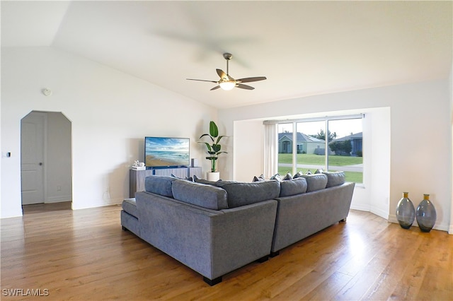 living room featuring hardwood / wood-style floors, ceiling fan, and vaulted ceiling