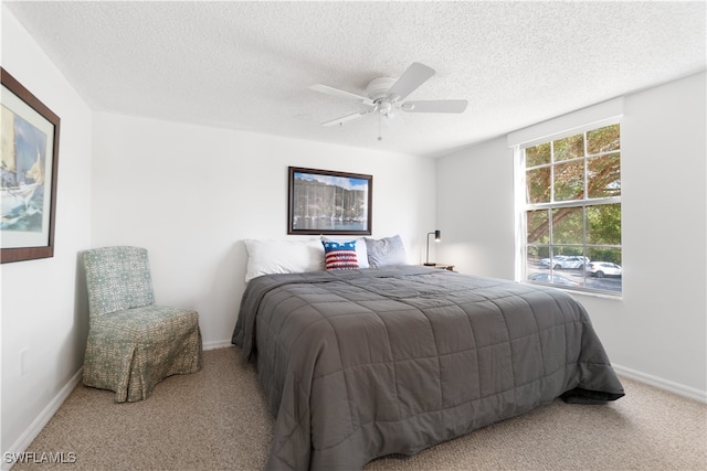 carpeted bedroom with a textured ceiling and ceiling fan