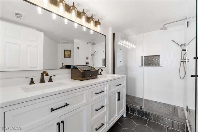 bathroom with vanity, an enclosed shower, and tile patterned flooring