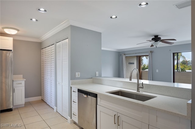 kitchen with appliances with stainless steel finishes, crown molding, sink, ceiling fan, and white cabinets