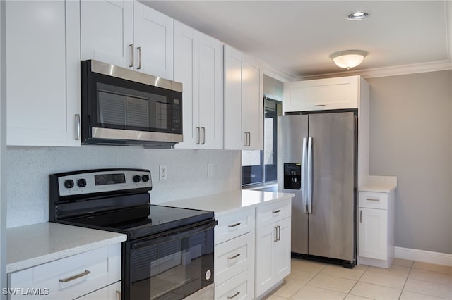 kitchen with light tile patterned flooring, white cabinetry, stainless steel appliances, and tasteful backsplash