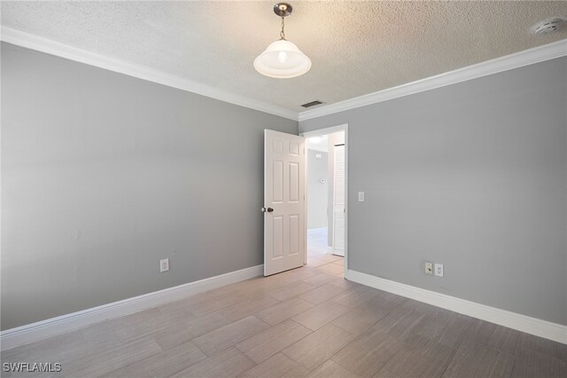 7012 Constitution Blvd Unit 206, Fort Myers, FL 33967 - unfurnished room with crown molding, a textured ceiling, visible vents, and wood finished floors