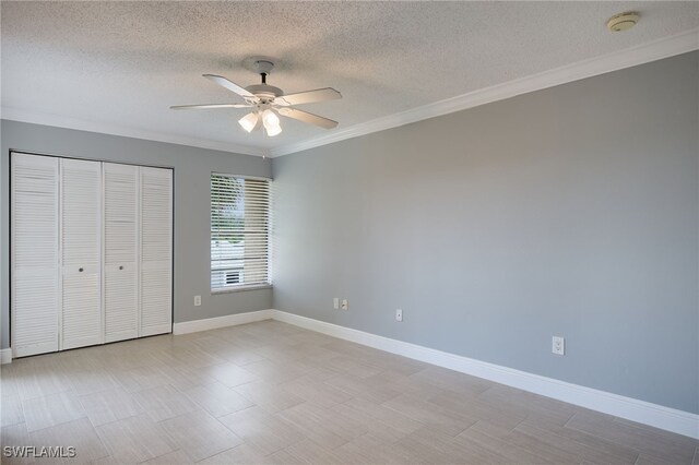 7012 Constitution Blvd Unit 206, Fort Myers, FL 33967 - unfurnished bedroom with a closet, ornamental molding, a textured ceiling, and baseboards
