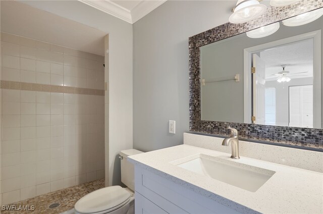 7012 Constitution Blvd Unit 206, Fort Myers, FL 33967 - bathroom with ceiling fan, vanity, toilet, ornamental molding, and tiled shower