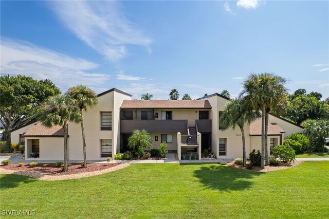 7012 Constitution Blvd Unit 206, Fort Myers, FL 33967 - back of property featuring a yard and stucco siding