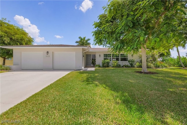 view of front of home with a garage and a front yard