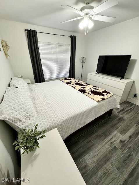 bedroom featuring ceiling fan and dark hardwood / wood-style flooring