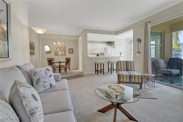 carpeted living room featuring a notable chandelier and ornamental molding