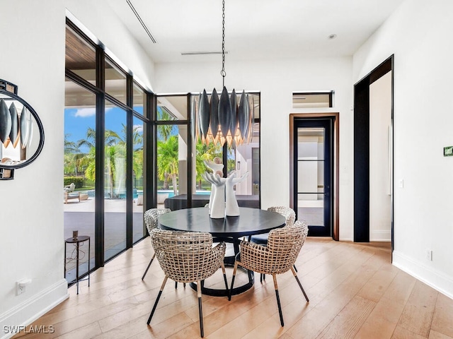 dining area featuring light wood-type flooring and a wealth of natural light