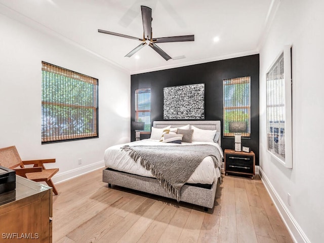 bedroom featuring ceiling fan, light hardwood / wood-style flooring, and ornamental molding