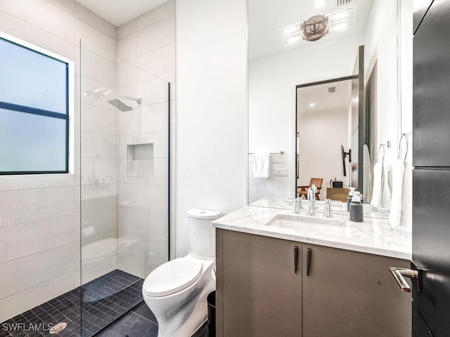 bathroom with toilet, a shower with shower door, and vanity