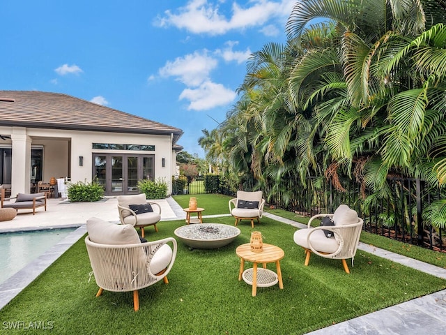 view of yard with french doors and a patio