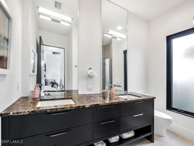 bathroom featuring toilet, tile patterned flooring, and vanity