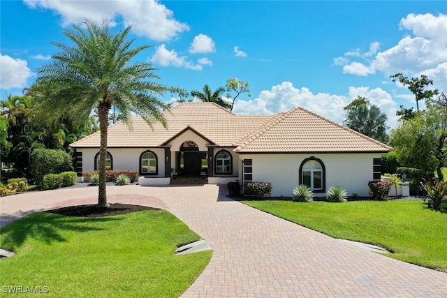 mediterranean / spanish house with a front yard