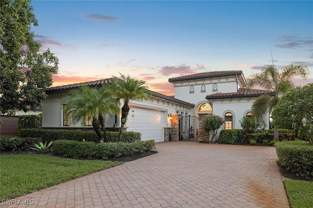 mediterranean / spanish-style home with a garage