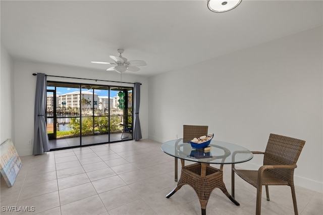 dining space featuring ceiling fan and light tile patterned floors