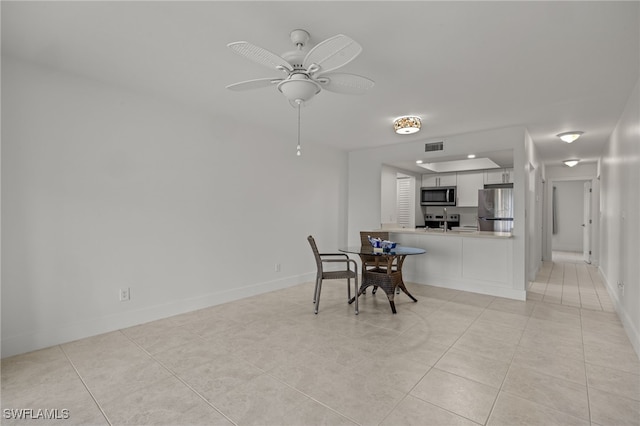 dining space featuring ceiling fan and light tile patterned floors