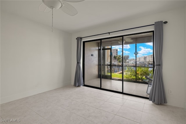 unfurnished room featuring light tile patterned flooring and ceiling fan