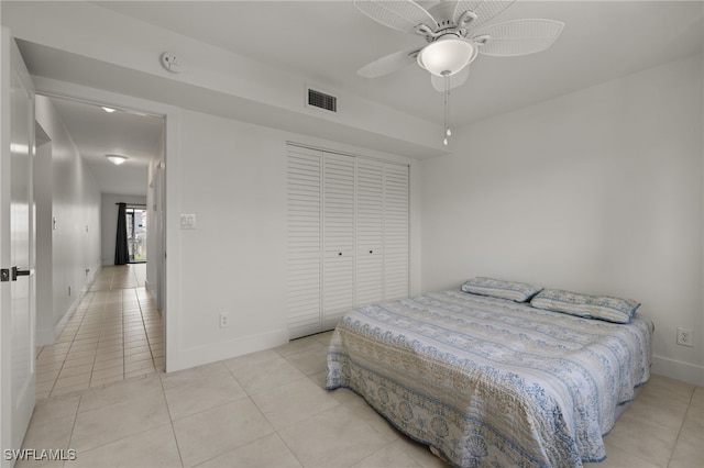 tiled bedroom featuring a closet and ceiling fan