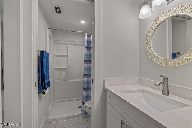 bathroom featuring a shower with shower curtain, toilet, vanity, and tile patterned floors