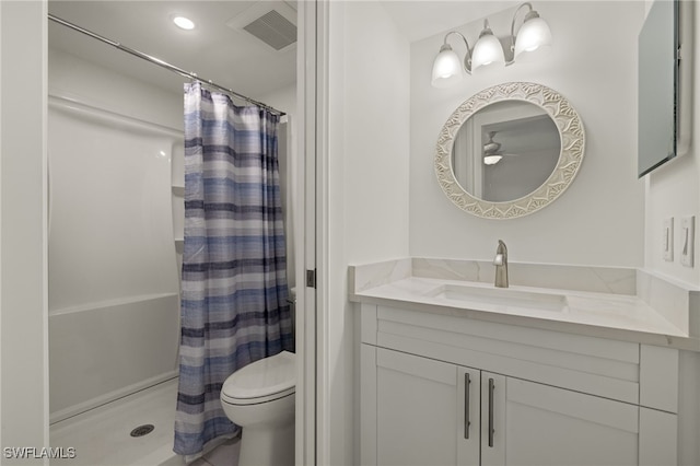 bathroom featuring vanity, toilet, and walk in shower