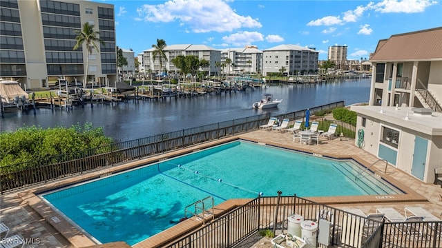 view of pool with a water view and a patio