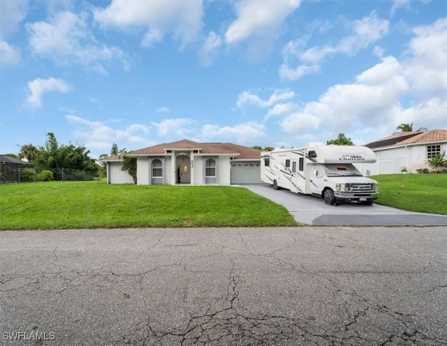 mediterranean / spanish-style house with a garage and a front lawn