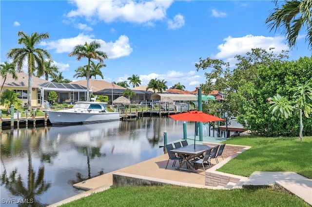 view of dock with a water view and a yard